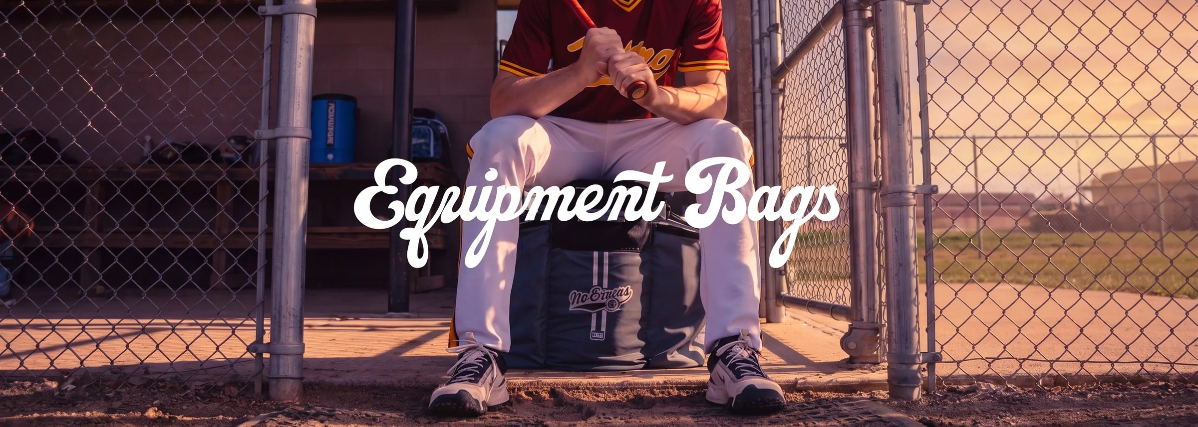Serious baseball, softball players, teams and coaches carrying heavy-duty No Errors equipment bags at a field.