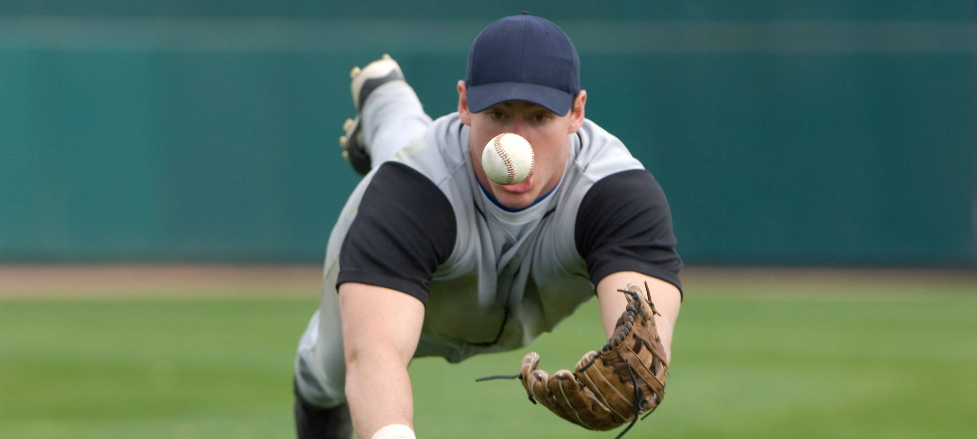 Outfielder diving for ball with No Errors baseball glove 