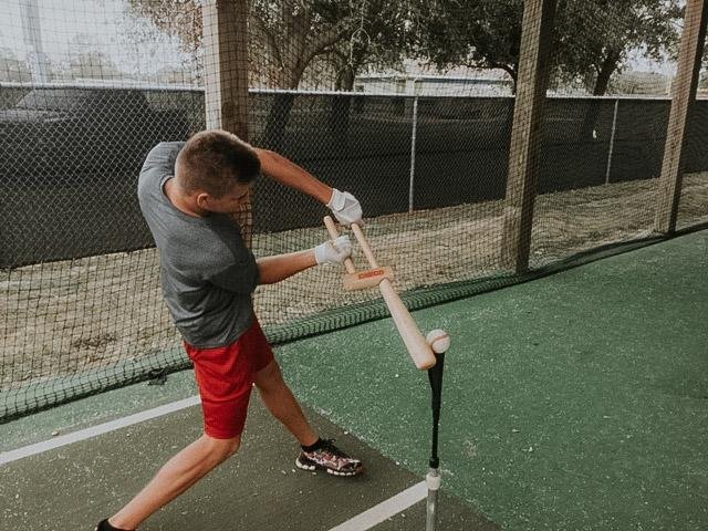 Baseball swing trainer on tee for hand path and sequencing drills