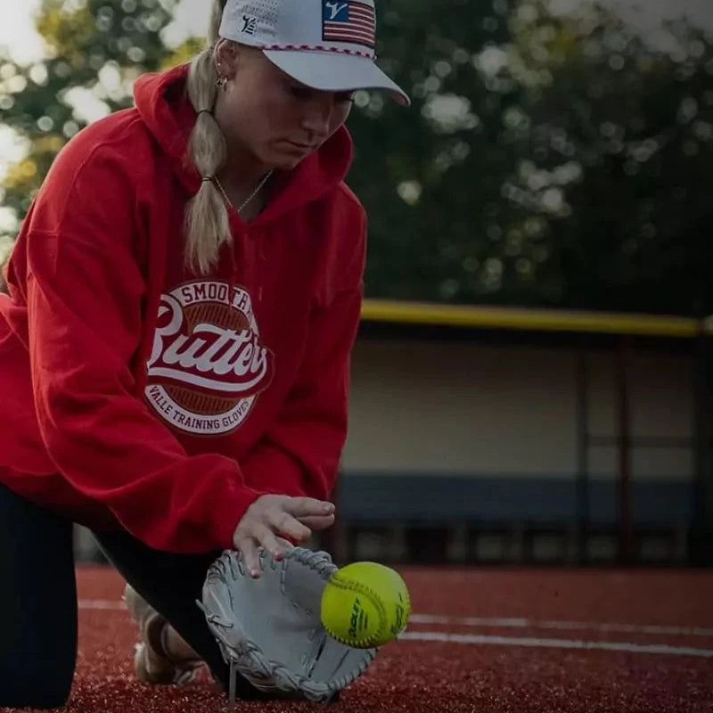 Softball player using Valle glove trainer to improve fielding skills and hand positioning.