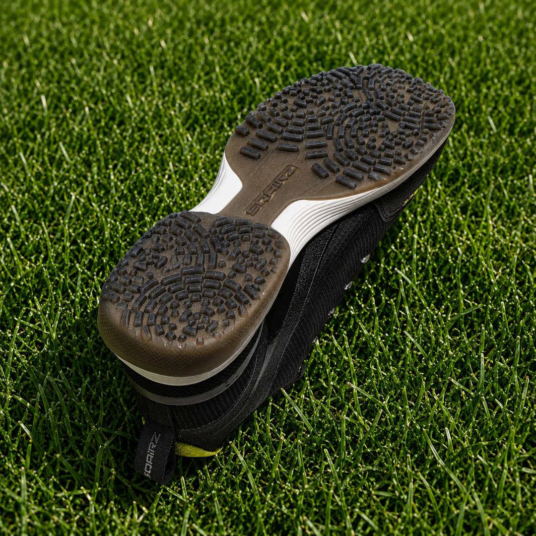 Rear heel on black SQAIRZ GFP2 softball turf shoe featuring integrated stability support for balance and comfort